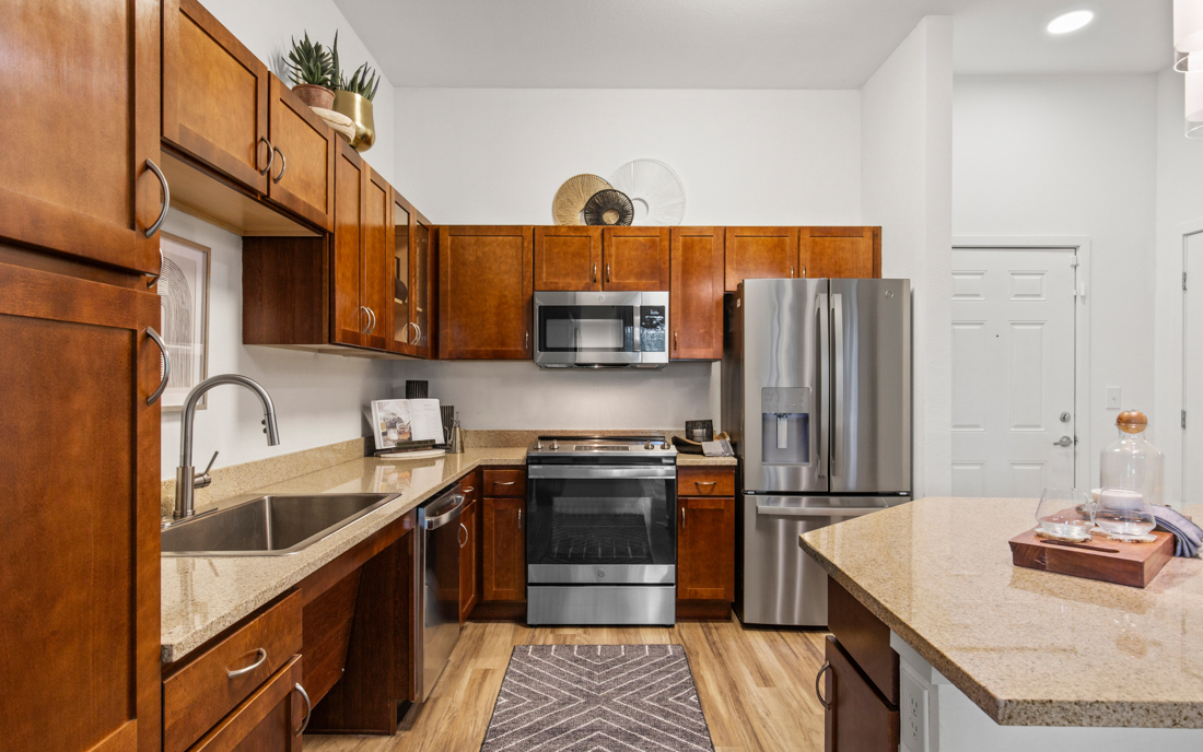 Apartments near Saddle Rock Golf Course - The Sanctuary At Tallyn's Reach Kitchen with granite countertops and kitchen islands