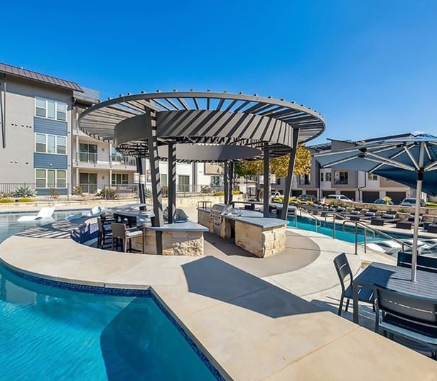 the Domain apartments - The Addison Apartments Poolside lounge with ample seating