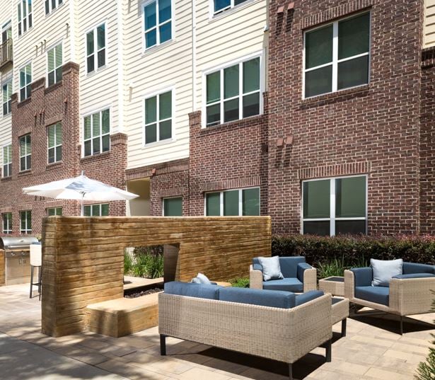 Texas Medical Center apartments - District At Greenbriar Outdoor resident lounge with fireplace
