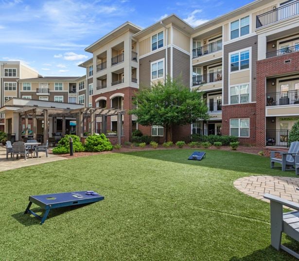 Central Raleigh Apartments in Crabtree - Marshall Park Cornhole lawn in North courtyard