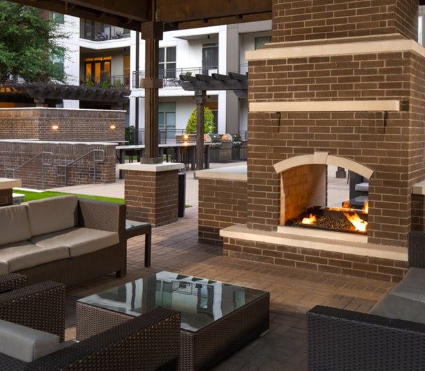 Strata Apartments - Outdoor cabana with fireplace and lounge - Knox-Henderson Apartments