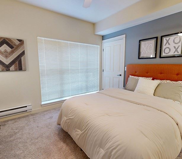 The Lodge at Redmond Ridge apartments near Aerotek - Model bedroom with large windows