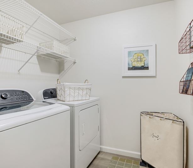 Victory Flats apartments in Beaverton - Large laundry room shelving and full size washer and dryer
